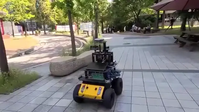 ODS-Bot navigating an outdoor pedestrian walkway.